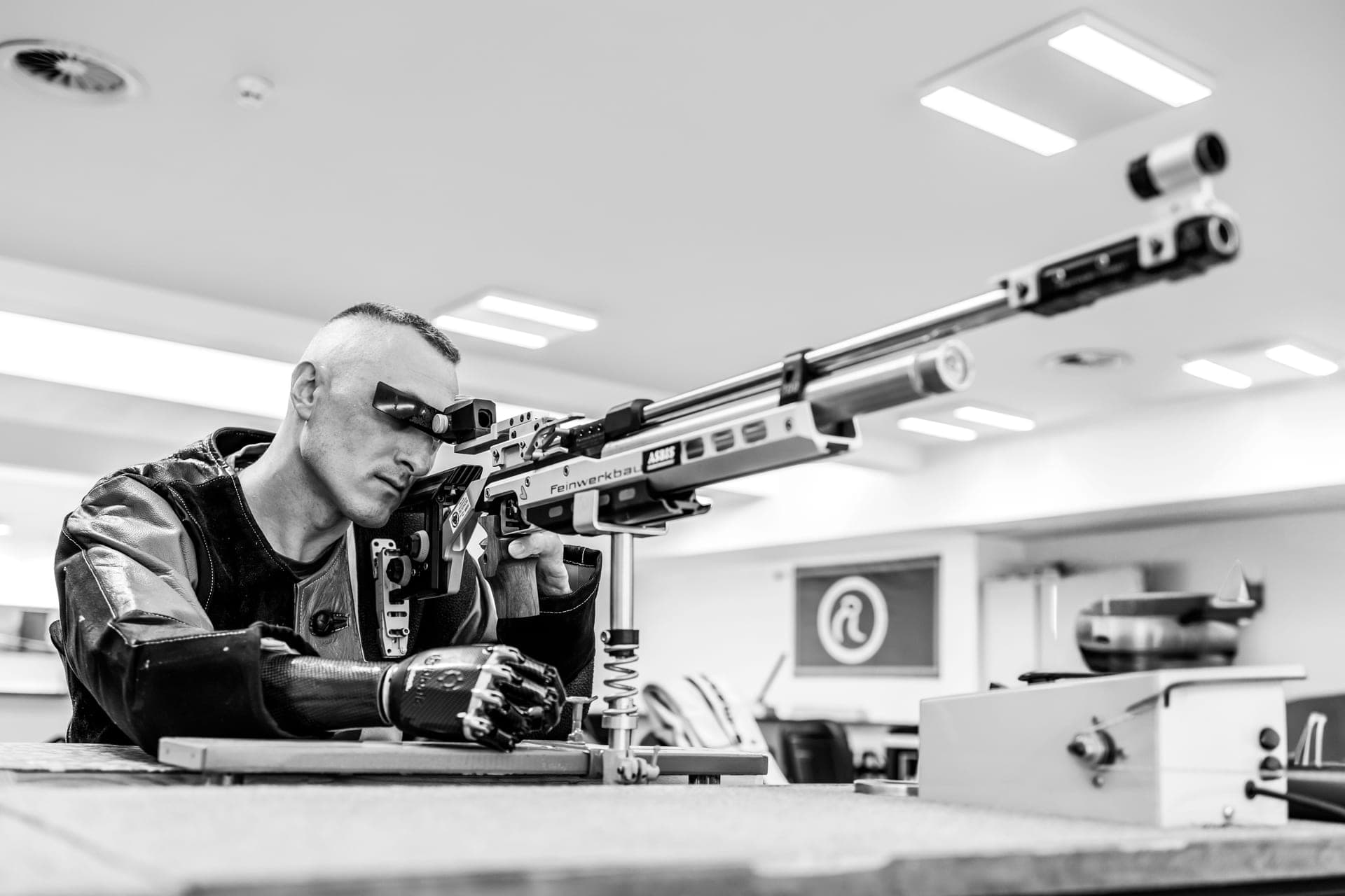An air-rifle shooter concentrating on a shot at an indoor range