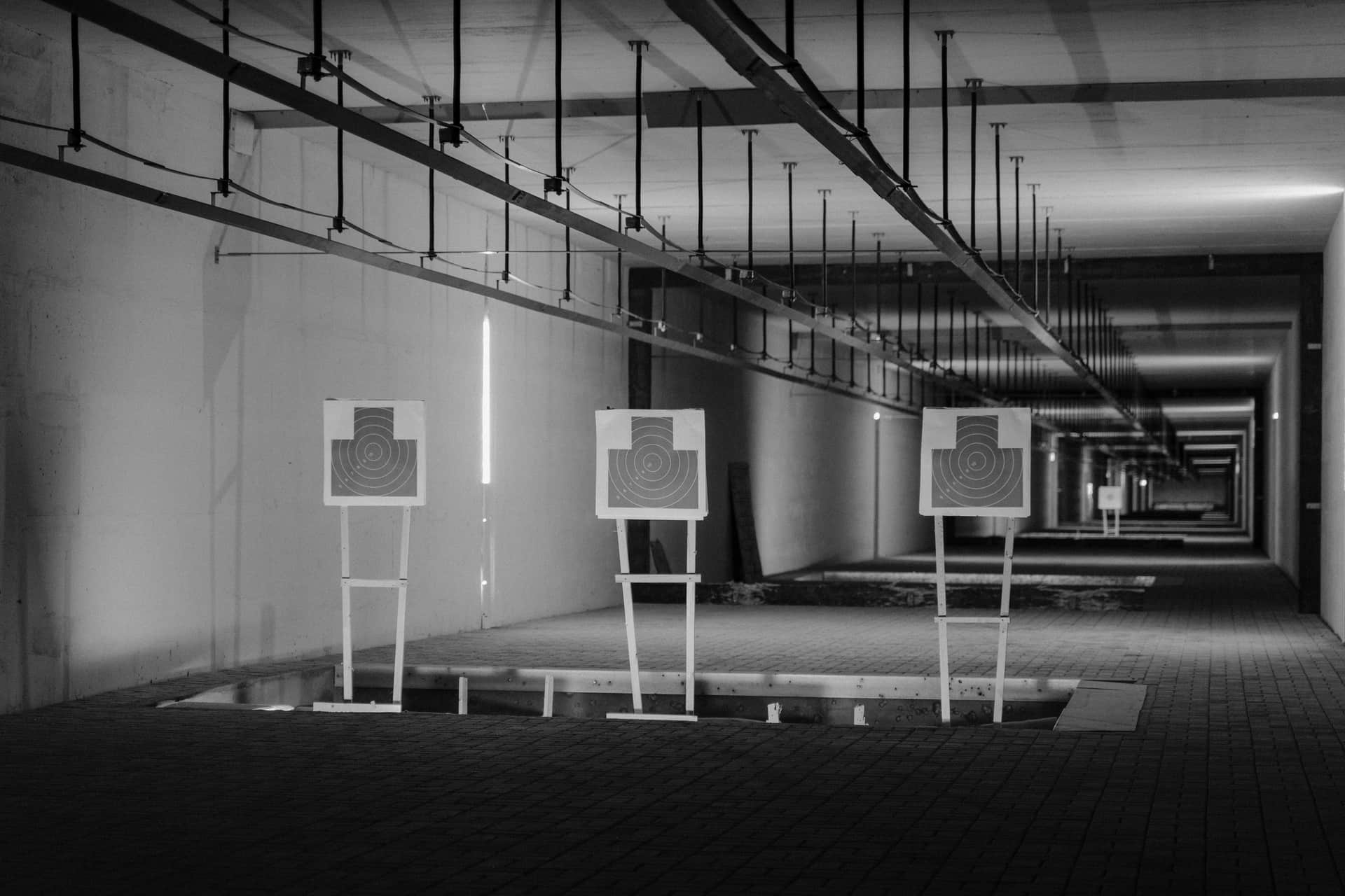 Targets on an indoor shooting range, in black and white